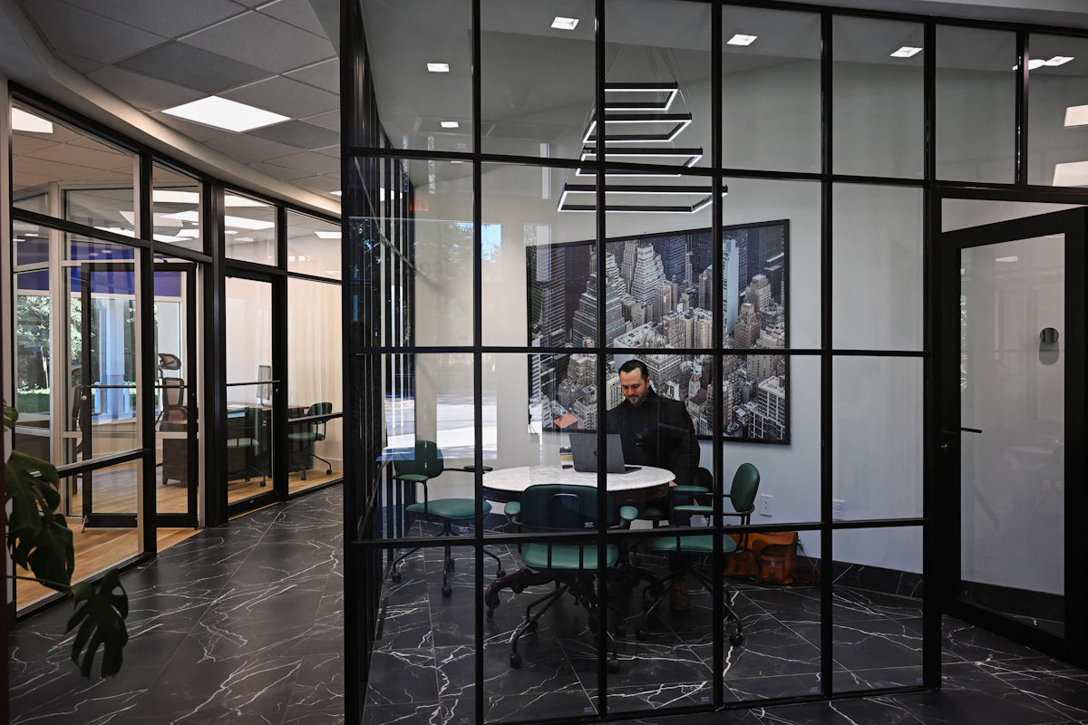 Professional working in a contemporary glass-walled office