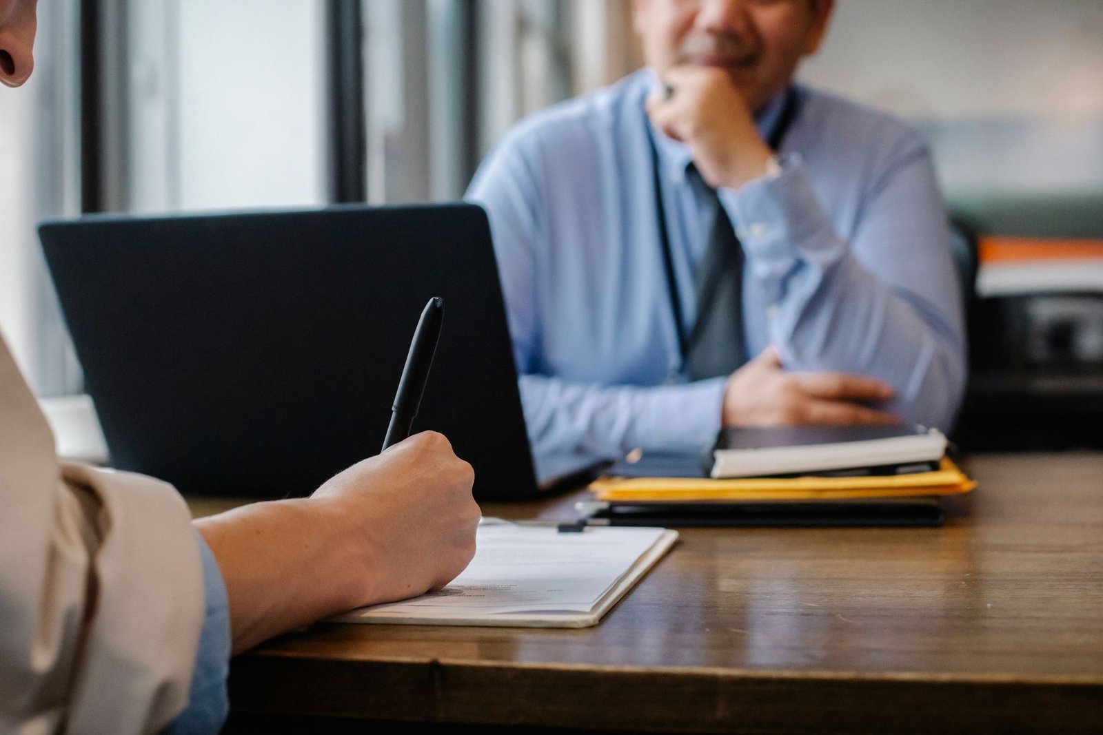 A recruiter reviewing application documents with a candidate